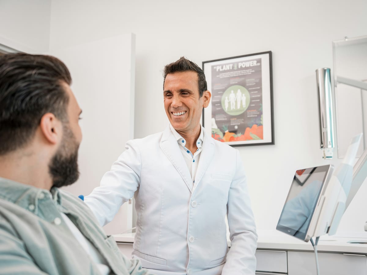 Dentist talking with a patient in a bright treatment room